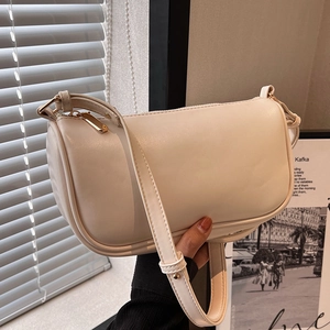 Chic beige PU leather pillow shoulder bag with gold zipper and minimalist urban design