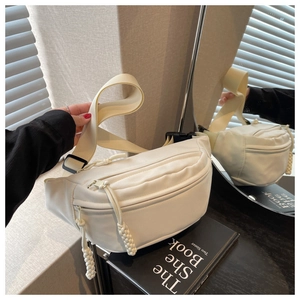 Detail of off-white canvas waist bag showing woven rope zipper and adjustable strap