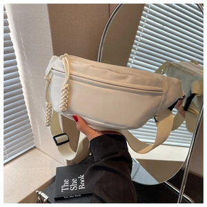 Detailed back view of white canvas crossbody bag with wide adjustable strap and plastic buckle