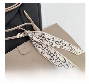 Detail of beige lychee leather tote with silk scarf decor and fashion embossed logo