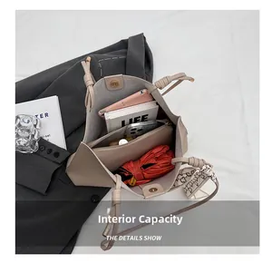Top view showing the spacious interior of the beige tote bag with daily essentials inside