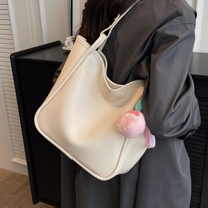 Cream large capacity faux leather tote bag with peach plush charm for daily commute