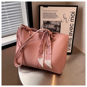 Detailed shot of pink lychee leather tote bag with silk scarf and drawstring closure
