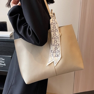Beige faux leather large tote bag with decorative silk scarf on shoulder strap