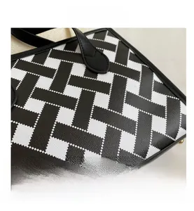 Detail of high-quality lychee grain leather with black and white geometric woven pattern