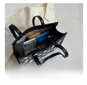 Spacious tote bag interior showing large capacity for umbrella, wallet and phone essentials