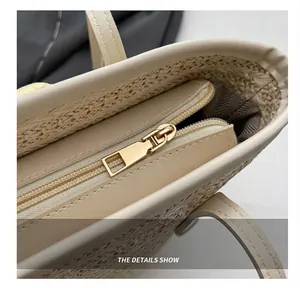 Close-up of smooth metal zipper and herringbone lining on woven straw tote bag