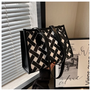 Close-up of a high-capacity tote bag with black and white geometric woven texture