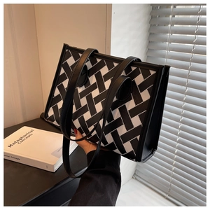 Macro detail of the black and white geometric woven pattern on this large tote bag