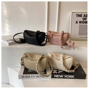 Detail of four textured leather dumpling bags with woven handles and horse pendants