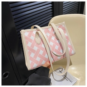 Detail of pink and white checkered tote bag with woven texture on a beige chair
