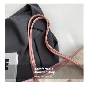 Close-up of comfortable pink shoulder straps and woven leather texture on tote bag