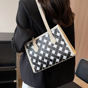 Minimalist woven tote bag in black and white geometric pattern with faux leather straps