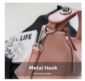 Close-up of polished silver hardware hook and smooth pink leather strap of the bag