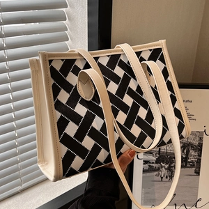 Large capacity black and white woven tote bag with dual straps and premium faux leather trim