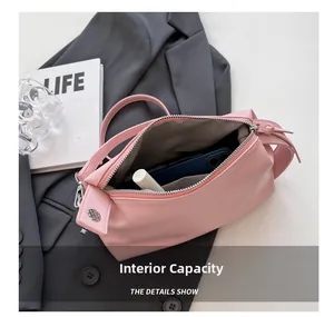 Internal capacity of pink shoulder bag showing interior pocket and everyday essentials
