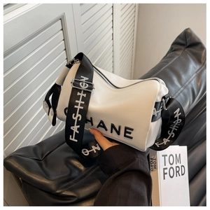 Detail view of white lychee textured shoulder bag with HANE lettering and wide strap