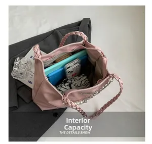 Pink quilted tote bag interior view showing large capacity for tablets and phones