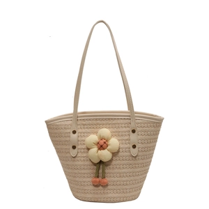 Summer woven straw shoulder bag with a large floral decoration and white leather straps