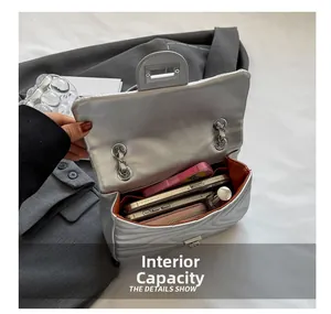 Internal capacity of silver quilted chain bag showing space for smartphone and wallet