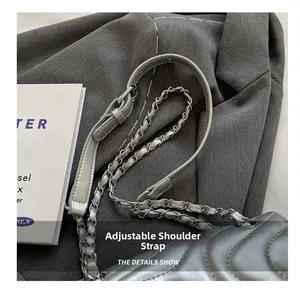 Detail of adjustable silver chain strap on quilted shoulder bag for women