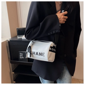 Detail of white boston bag with LHANE logo and ASH lettering on wide strap