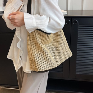 Straw woven shoulder tote bag with black leather trim and contrasting strap design