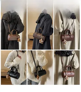 Multiple styles showing a leather Boston bag with a teddy bear charm for women
