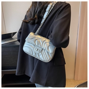 Silver quilted chain shoulder bag shown on professional model with metallic finish