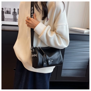 Close-up of black grainy PU leather Boston bag with printed wide shoulder strap