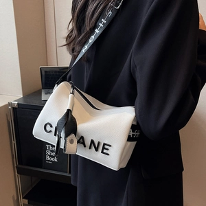 White lychee leather shoulder bag with embossed CANE letters and sporty wide strap