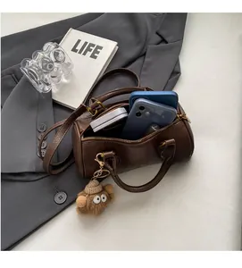 Spacious interior of dark brown Boston bag showing capacity for phone and cosmetics