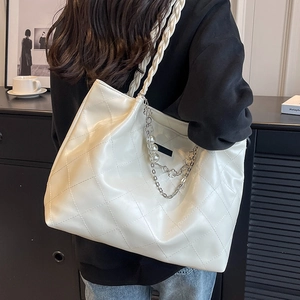 Large cream woven tote bag with quilted pattern, pearl chain strap, and casual style