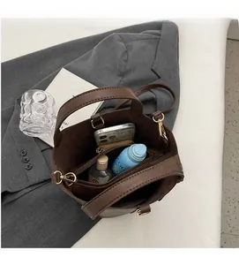 Detail showing spacious interior of dark brown tote bag with zipper pocket and daily essentials