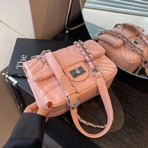 Pink quilted crossbody bag with silver chain strap and classic V-stitch leather pattern