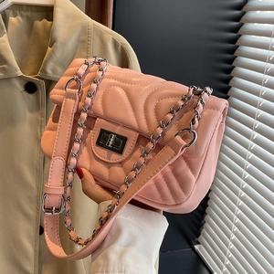 Pink quilted leather crossbody bag with silver chain strap and metal turn-lock