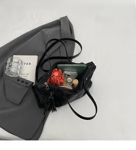 Top-down view of spacious interior of black leather tote bag showing high capacity storage