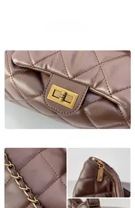 Detail of dark brown quilted leather bag featuring vintage gold twist lock and chain strap