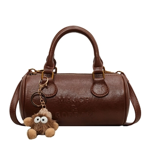 Retro dark brown Boston barrel bag in textured faux leather with plush doll pendant