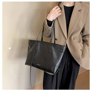 Detail of black tote bag featuring crocodile embossed texture and Fashion Bags logo print