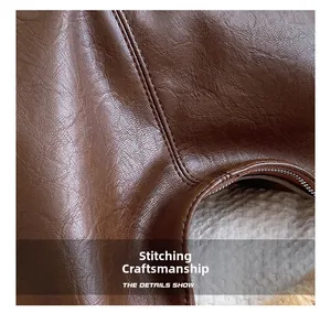 Close-up of brown leather tote bag showing detailed double stitching and fine texture