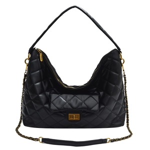 Quilted black tote bag with gold chain strap and turn-lock closure in classic retro style