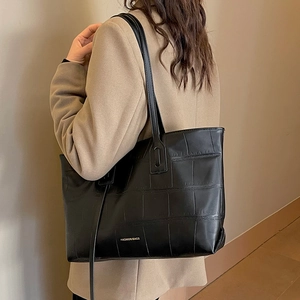 Black crocodile embossed tote bag for women with gold lettering and shoulder straps