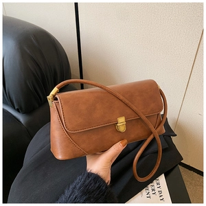 Détails de la texture du sac vintage marron et de la boucle en métal doré élégant