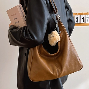 Brown faux leather tote bag for women with cute plush bear charm and shoulder strap