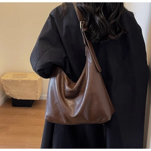 Détail du sac hobo vintage marron foncé avec sa bandoulière large et ajustable