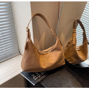 Detail of brown matte suede hobo bag with adjustable strap and vintage gold hardware