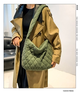 Green quilted corduroy crossbody tote bag styled with a khaki trench coat for autumn fashion