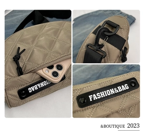 Close-up of quilted khaki nylon saddle bag with black zipper and fashion brand logo