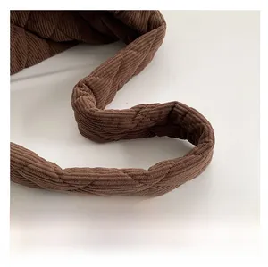 Detail of coffee corduroy shoulder strap featuring soft quilted rhombus pattern texture